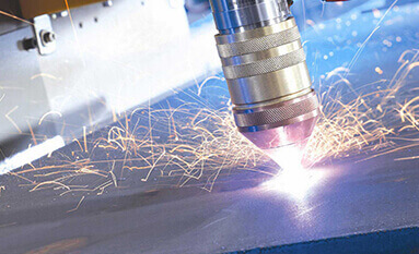 A close up of sparks being emitted from a laser machine during a plasma cutting application.