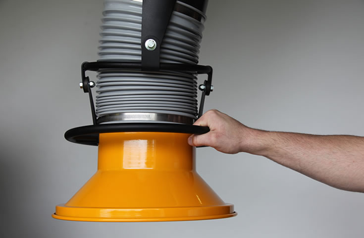 A machine operator holding onto a fume extractor arm. An emphasis on the effortless 360° rotation and 14-inch metal hood.