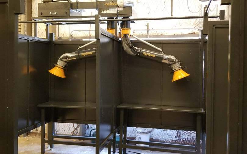 Welding booths with fume arms