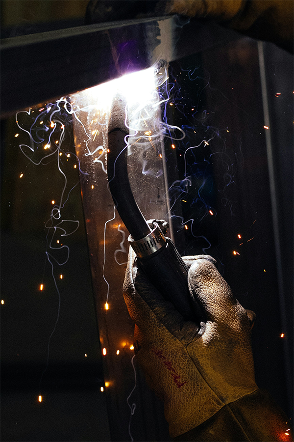 A welder working on a project in a confined space.