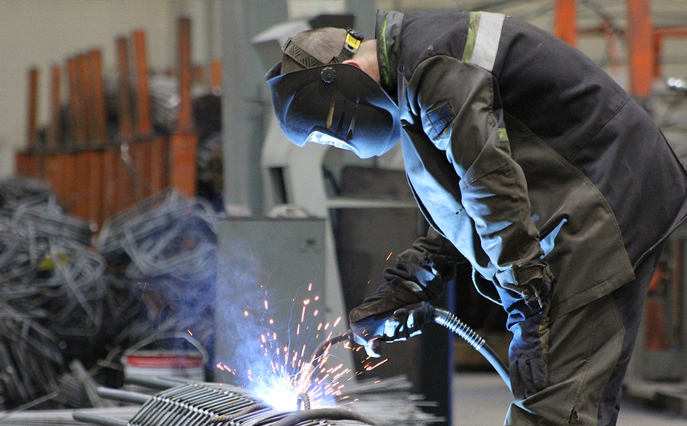 A machine operator working on an object.