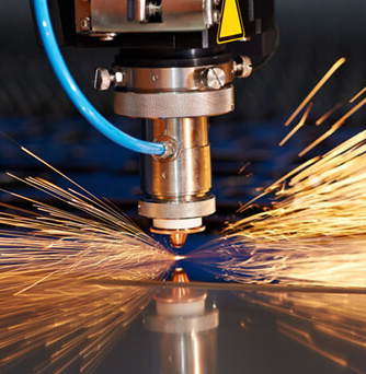 A laser cutting machine working on a project while sparks emit.