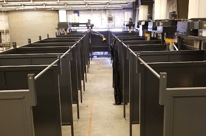 Welding booths and wall mounted fume extractors installed in a highschool workshop.