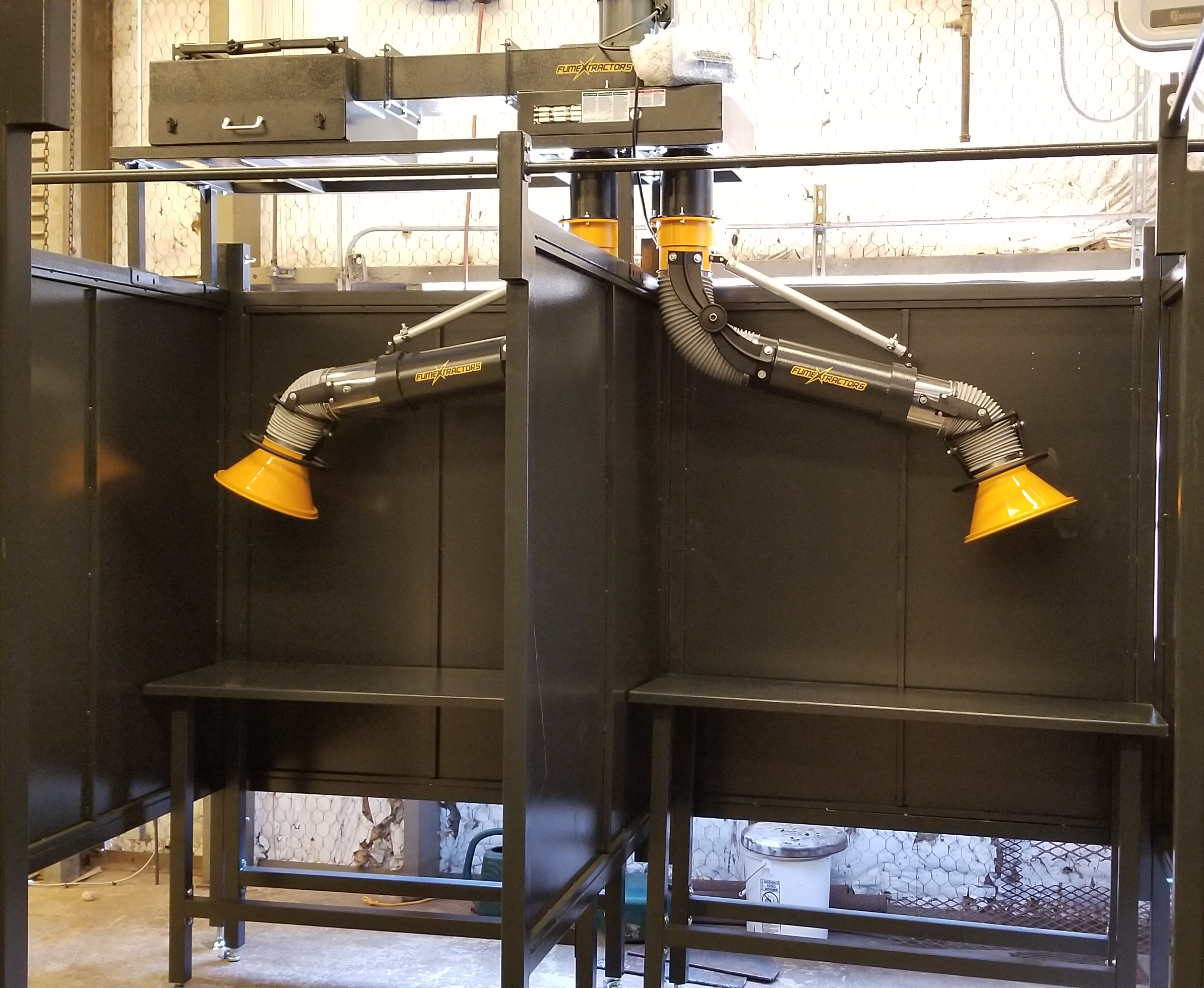 FumeXtractors welding booths and fume arms shown installed in a high school workshop to extract weld fumes and smoke.