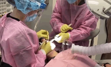 Dentists performing work on a patient