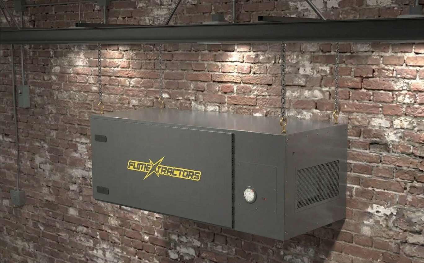 FumeXtractors industrial air cleaner hung from ceiling brackets in an industrial facility.