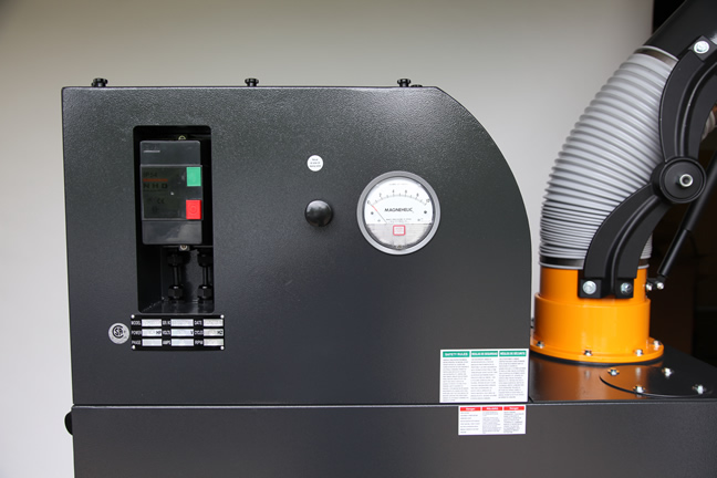 A close up of a portable fume extractors high-efficiency motor, UL-Approved control box  for pulse cleaning and filter change gauge.
