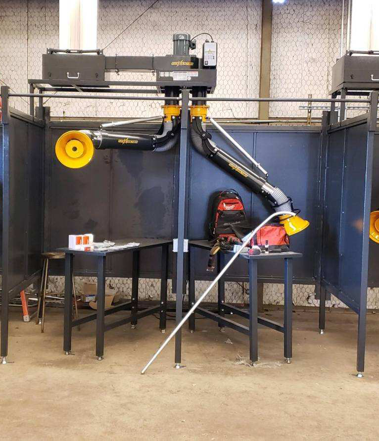 Fume Xtractors welding booths shown with fume extraction arms installed to remove fumes and smoke from a welding workshop.